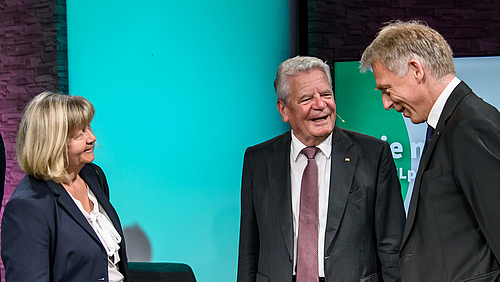 Die Hochschule beeindruckt. Joachim Gauck im Gespräch mit Kanzlerin Sylvia Bäßler und Prorektor Professor Volker Tolkmitt. Das Foto zeigt drei Personen bester Laune. In der Mitte Altbundespräsident Joachim Gauck dem Prorektor Prof. Volker Tolkmitt zugewandt, auf dem Biild rechts. Links ist Hochschulkanzlerin Sylvia Bäßler zu sehen, den Blick beiden Gesprächspartnern zugewandt.