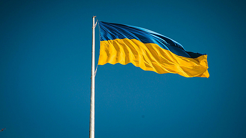 Die HSMW hilft vom Krieg Betroffenen. Die blaue-goldene Flagge der Ukraine weht an einem Fahnenmast im Wind